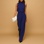 Women’s elegant halter jumpsuit with high waist, wide-leg silhouette, decorative tie, and side pockets. Perfect for parties and evenings out.
