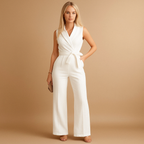 Women’s elegant wrap jumpsuit with tailored waist and wide-leg design, available in white, black, khaki, and pink. Ideal for business, formal, and stylish occasions.