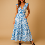 Women’s floral maxi dress with ruffles, deep V-neckline, waist cut-out, and high slit – perfect for summer weddings, parties, and evening events.