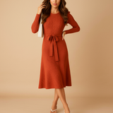 Women’s knitted autumn dress with long sleeves, round neck, and belt in beige, black, grey, red, and green – ideal for casual or office wear.