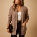 Women’s long cardigan with V-neck, relaxed fit, soft breathable fabric, and pockets. Perfect for layering, work, or casual everyday wear.