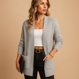 Women’s long cardigan with V-neck, relaxed fit, soft breathable fabric, and pockets. Perfect for layering, work, or casual everyday wear.